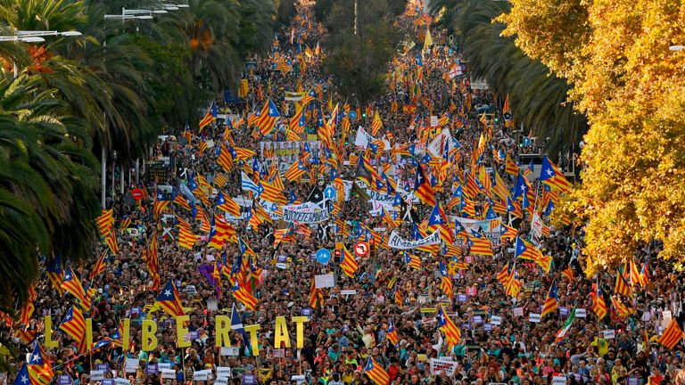 People wave Catalan pro-independence 'Estelada' flags during a peaceful pro-independence demonstration